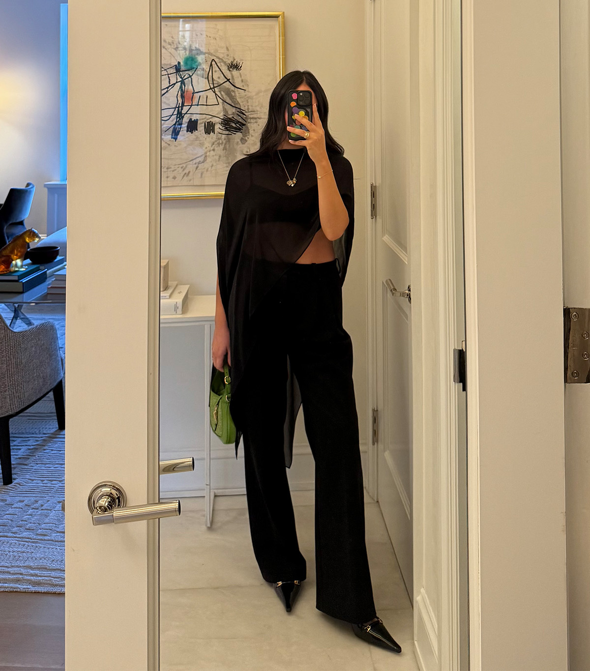 @nicoleakhtarzad taking a mirror selfie wearing a winter outfit.