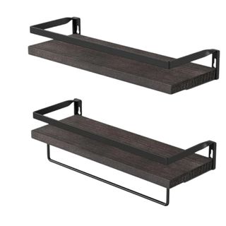 Two dark brown floating shelves with a black towel rack
