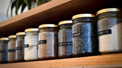 Labled glass jars on a pantry shelf