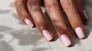 Image of pink shellac nails in the sunshine