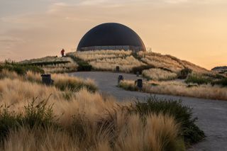 black dome surrounded by grassland