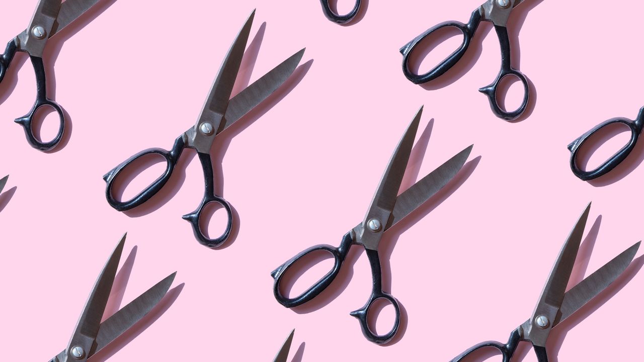 Repeated vintage scissors on pink background