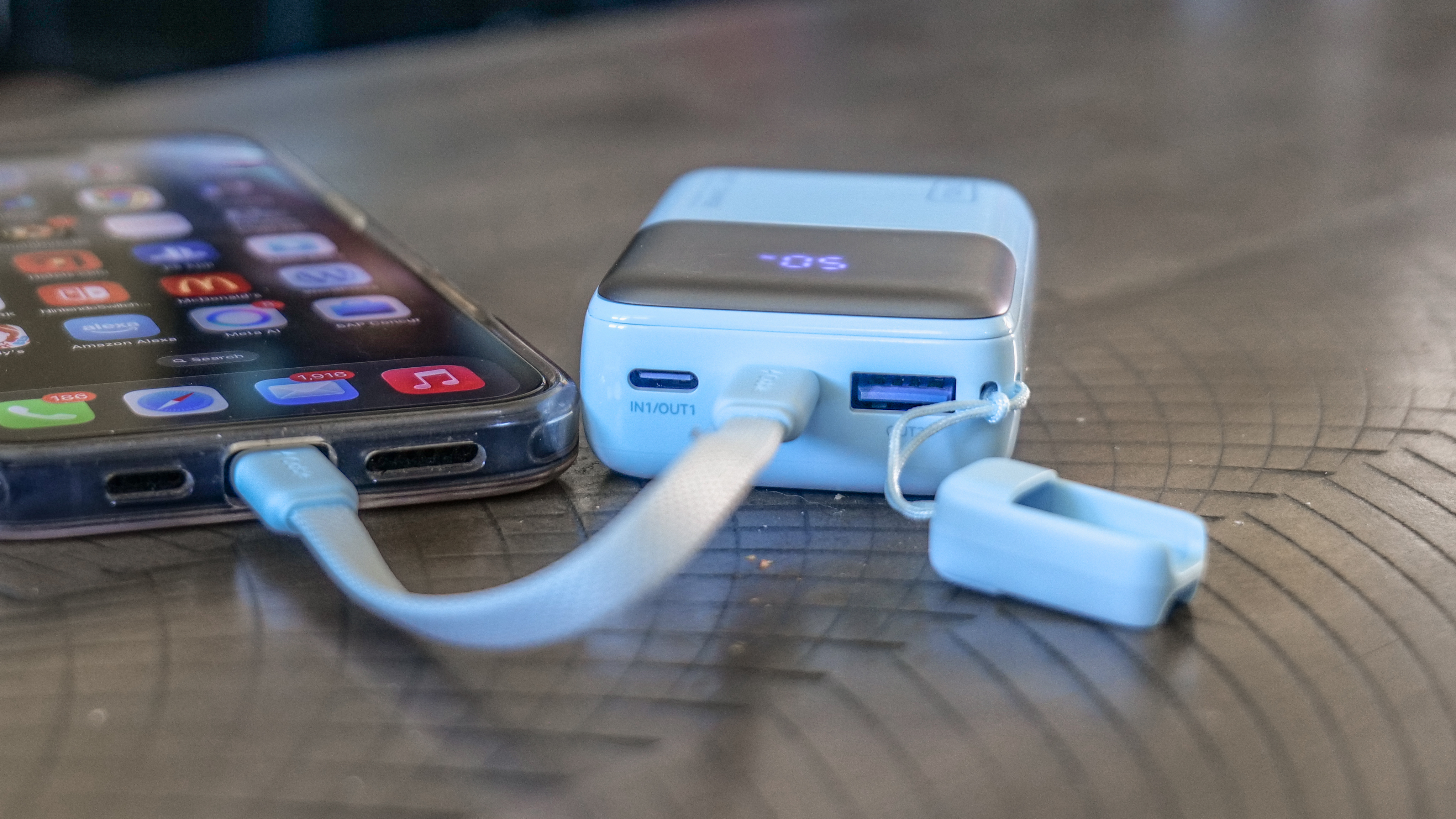 Iniu Pocket Rocket P50 charging a phone.