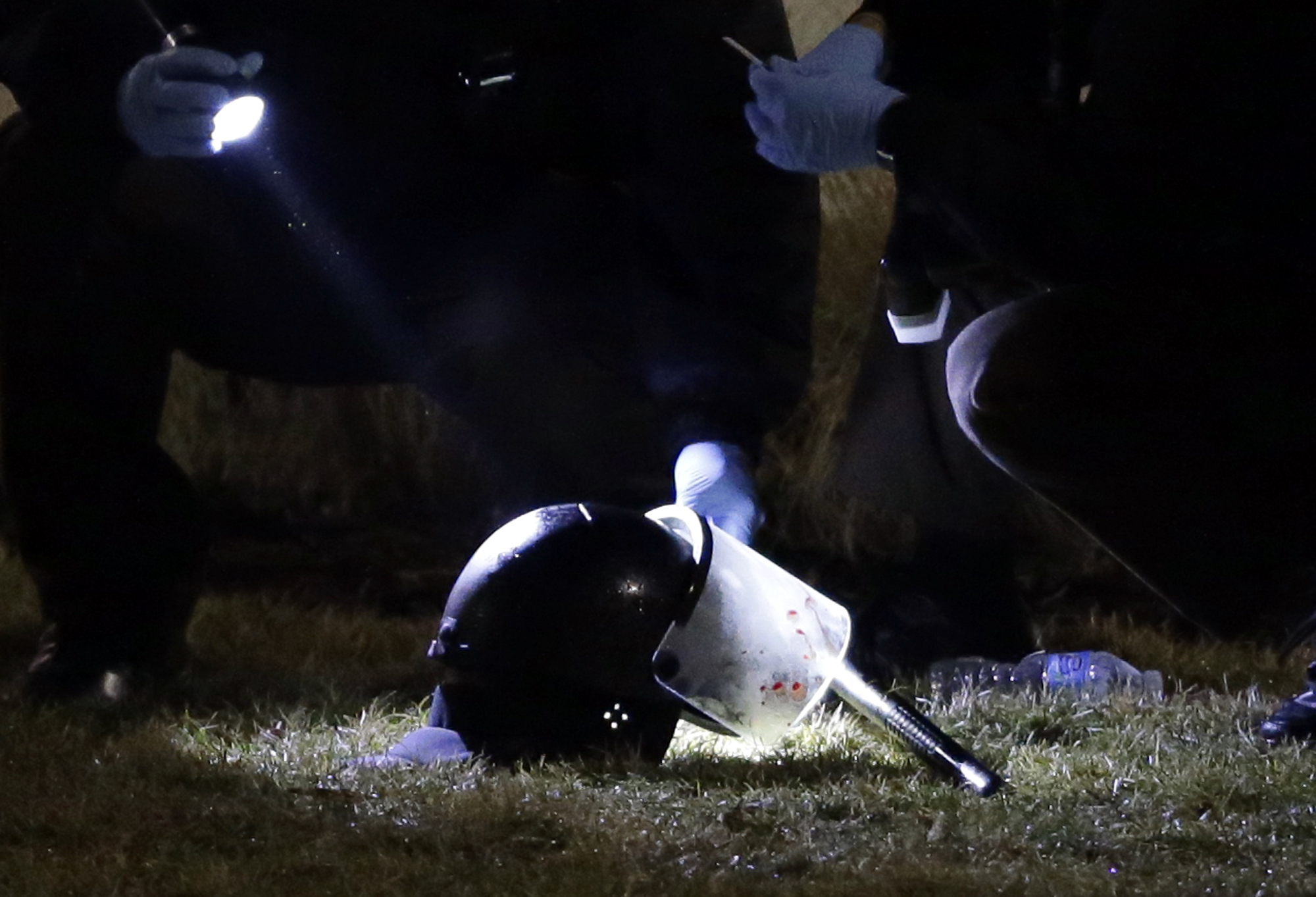 Police investigate the scene of the shooting.