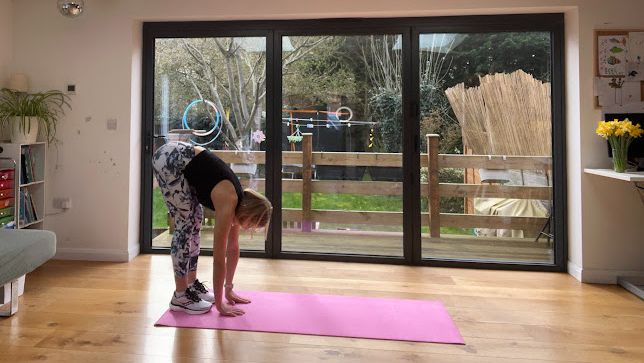 Woman starting the inchworm exercise