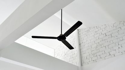 White ceiling beams and a black ceiling fan