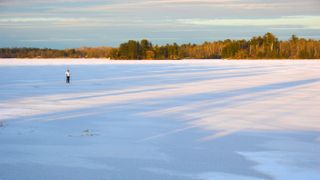 Cross-country skiing on the iced lake in Voyageurs National Park, Minnesota, USA