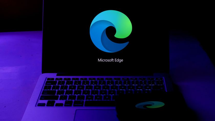 The Microsoft Edge logo on a black background displayed on a laptop screen.