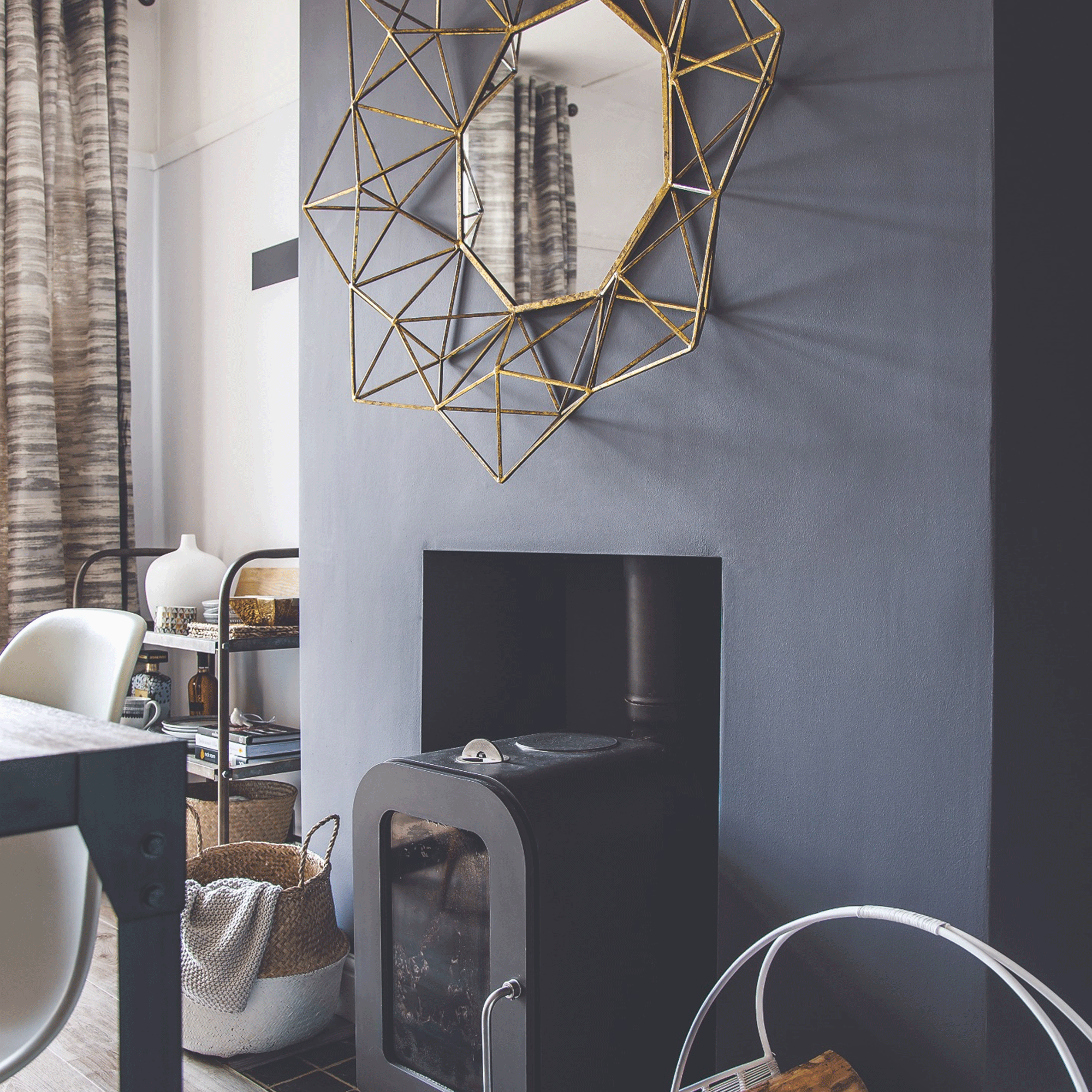 Grey dining room with stove and mirror