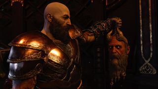 God of War Ragnarok's Kratos holds up the head of Mimir
