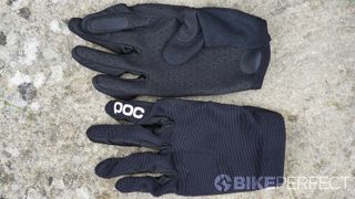 POC Essential DH gloves lying on a flat surface