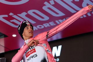 UAE Team Emirates XRG's Mexican rider Isaac Del Toro puts on the pink jersey of overall leader (Maglia Rosa) as he celebrates on the podium after placed second in the 19th stage of the 108th Giro d'Italia cycling race of 166kms from Biella to Champoluc on May 30, 2025. (Photo by Luca Bettini / AFP)