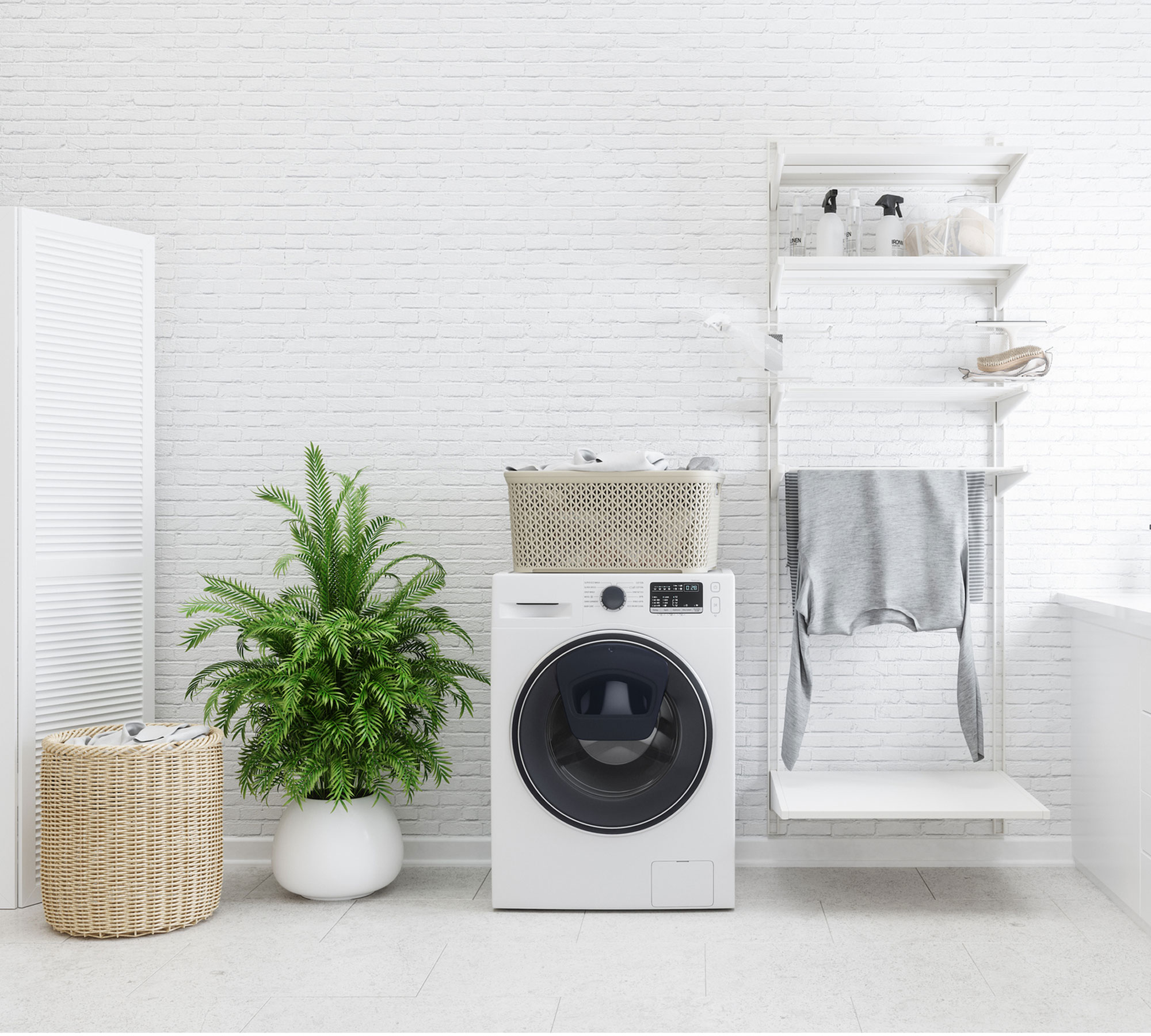 laundry room ideas - a white washing machine in a white tiled laundry room - GettyImages-1188826574