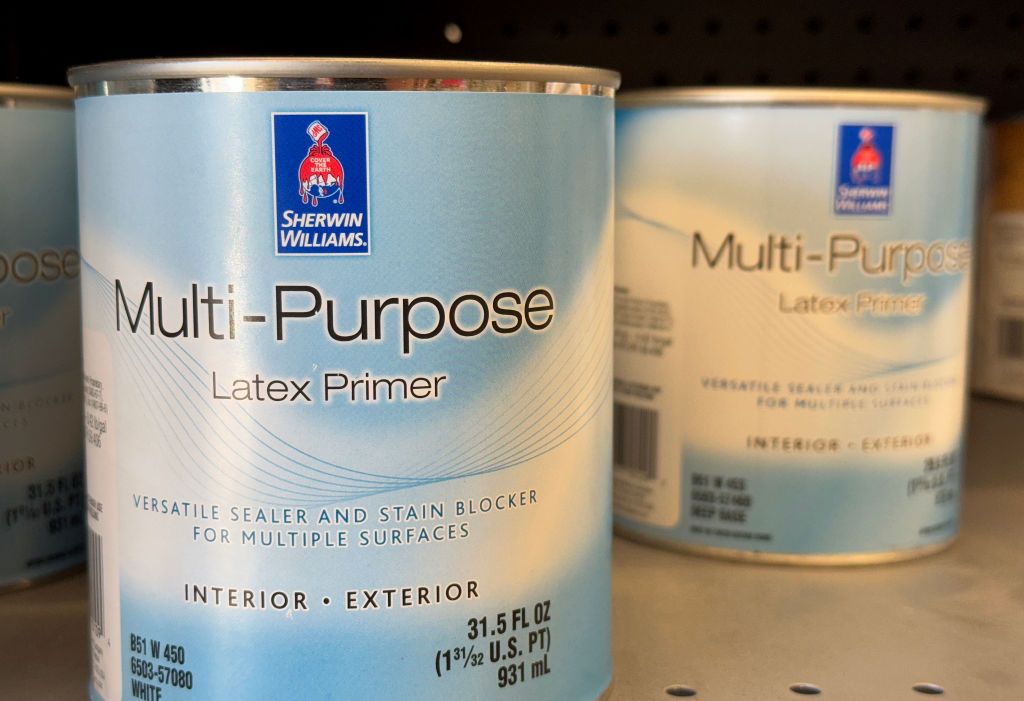 Cans of Sherwin-Williams multi-purpose latex primer are displayed on a shelf at a Sherwin-Williams store on October 22, 2024 in San Rafael, California