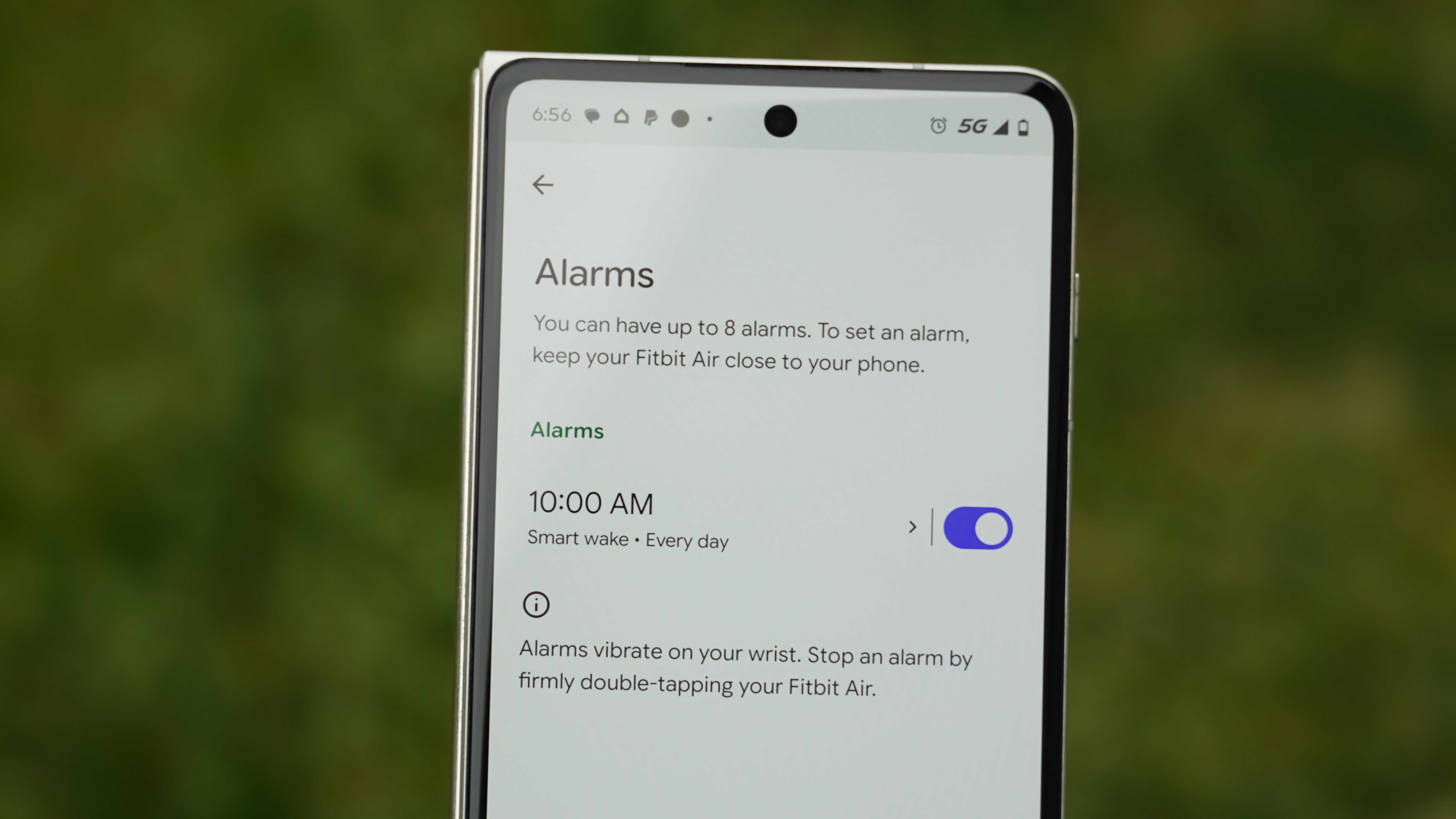The Fitbit Air in a Lavender band and the Google Health app settings.