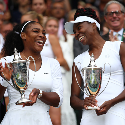 Venus Williams of The United States and Serena Williams of The United States hold their trophies following victory in the Ladies Doubles Final against Timea Babos of Hungary and Yaroslava Shvedova of Kazakhstan on day twelve of the Wimbledon Lawn Tennis Championships at the All England Lawn Tennis and Croquet Club on July 9, 2016 in London, England.