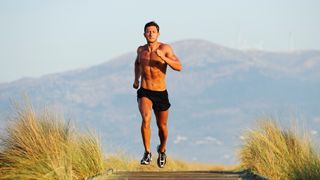 a photo of a man with abs running topless