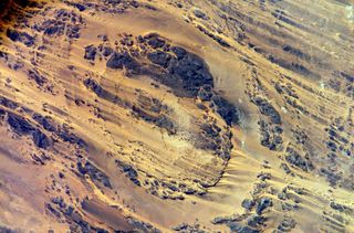 Astronaut Clayton C. Anderson tweeted this picture from space, a view of Aorounga Impact Crater, southeast of of Emi Koussi volcano in Chad.