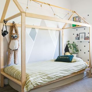 boys bedroom with painted feature wall and house style bed