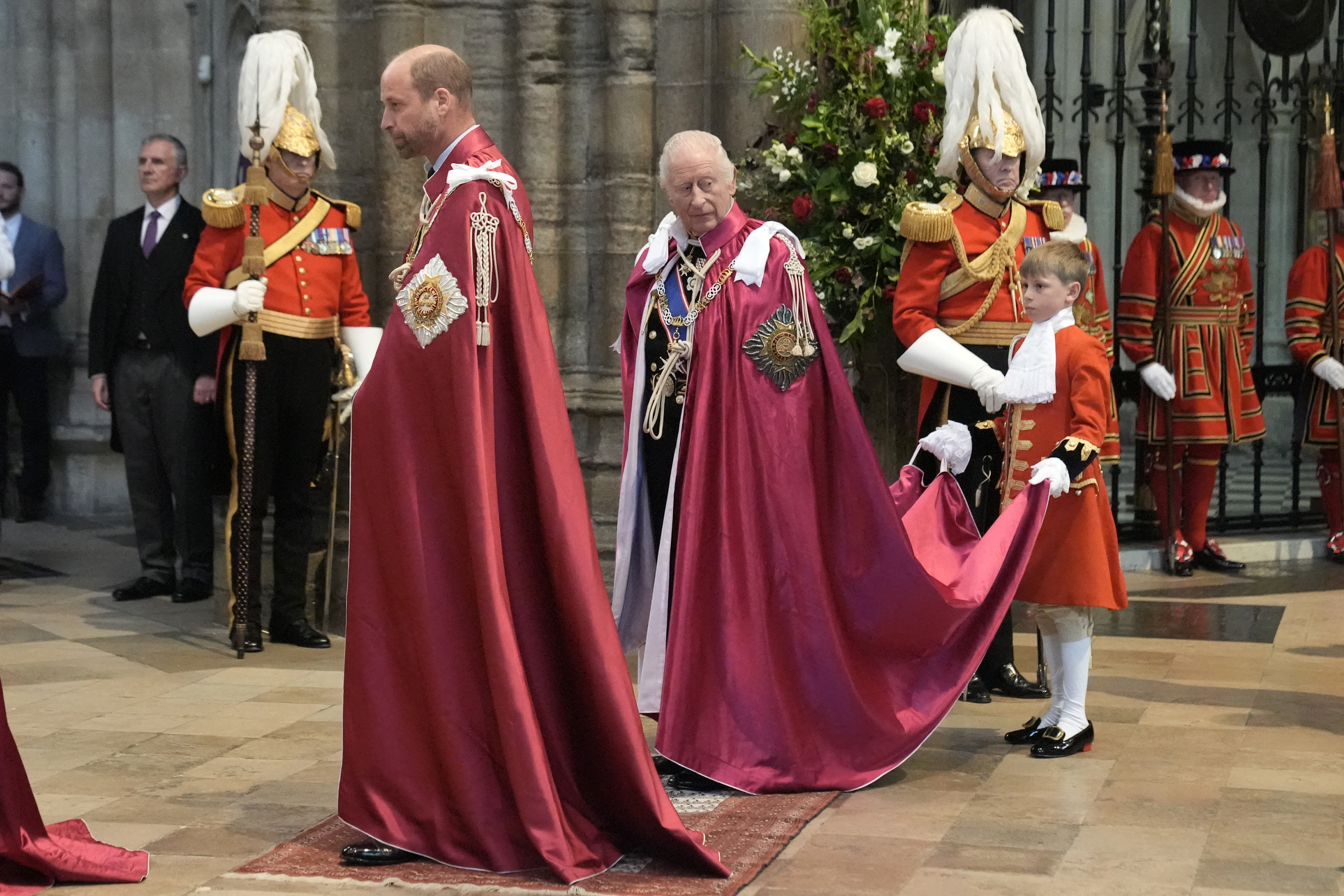 King Charles and Prince William wearing long red robes