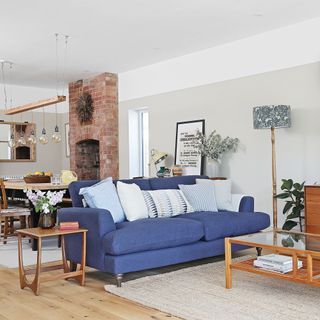 Open-plan living room with blue sofa and dining area