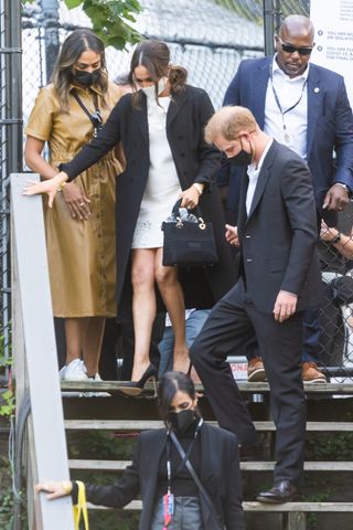 Meghan Markle and Prince Harry leave the Global Citizens Festival concert where Markle wears a Valentino dress and her Lady Dior bag in tribute to Princess Diana