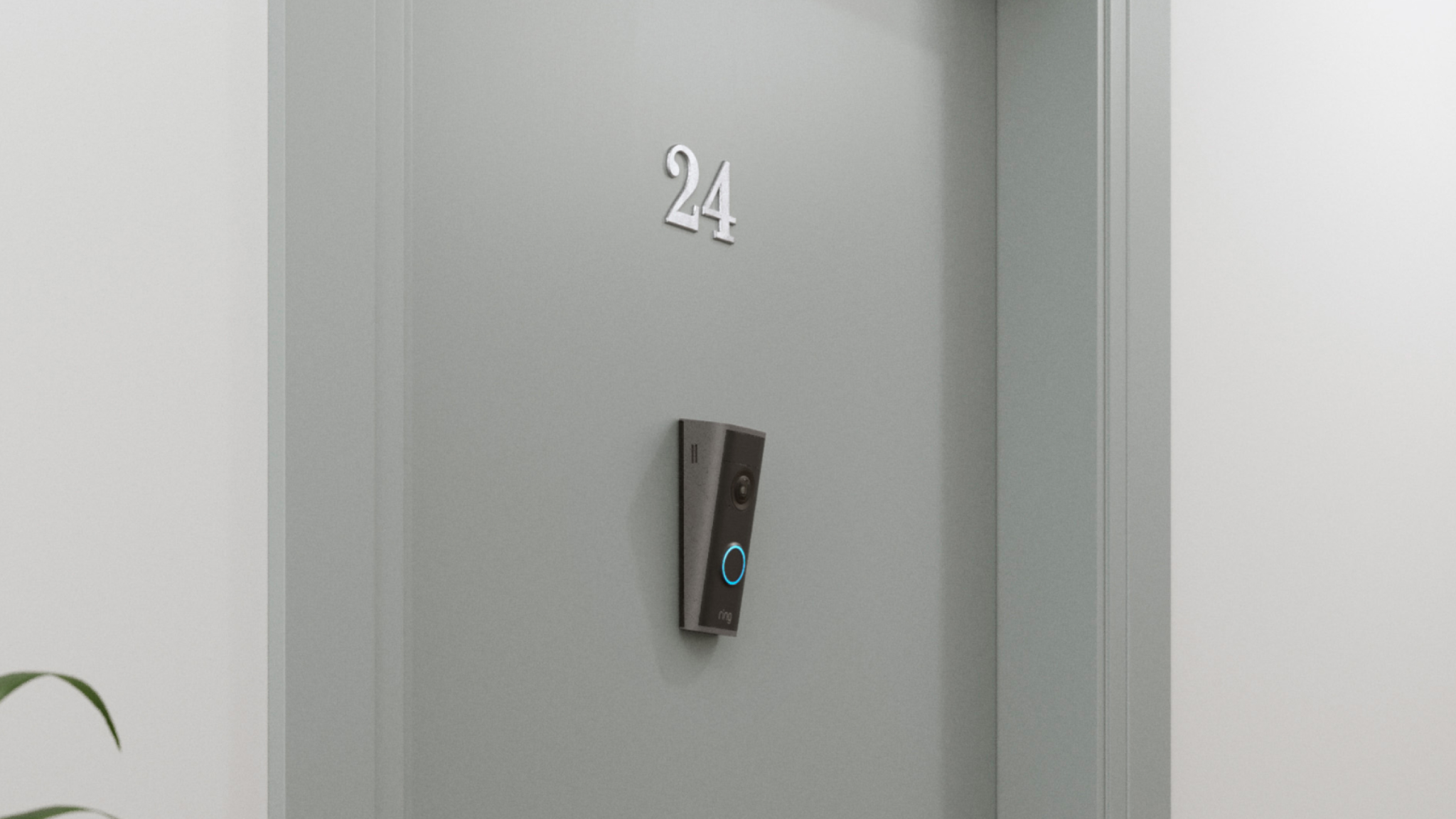 The Ring Peephole Camera 2K mounted on a grey door underneath the number 24