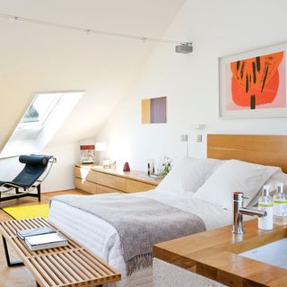 white attic bedroom with white double bed