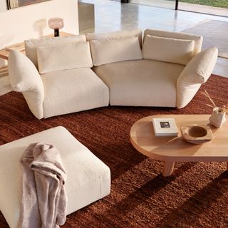 King Living Haven sofa in a living room with a brown rug and a matching ottoman