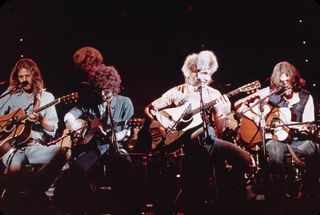 Members of the American soft-rock ensemble The Eagles sit on chairs as the perform on the television show 'Don Kirschner's Rock Concert,' 1979. Bandmembers are (left to right) Glenn Frey, Don Henley, Joe Walsh, and Don Felder.