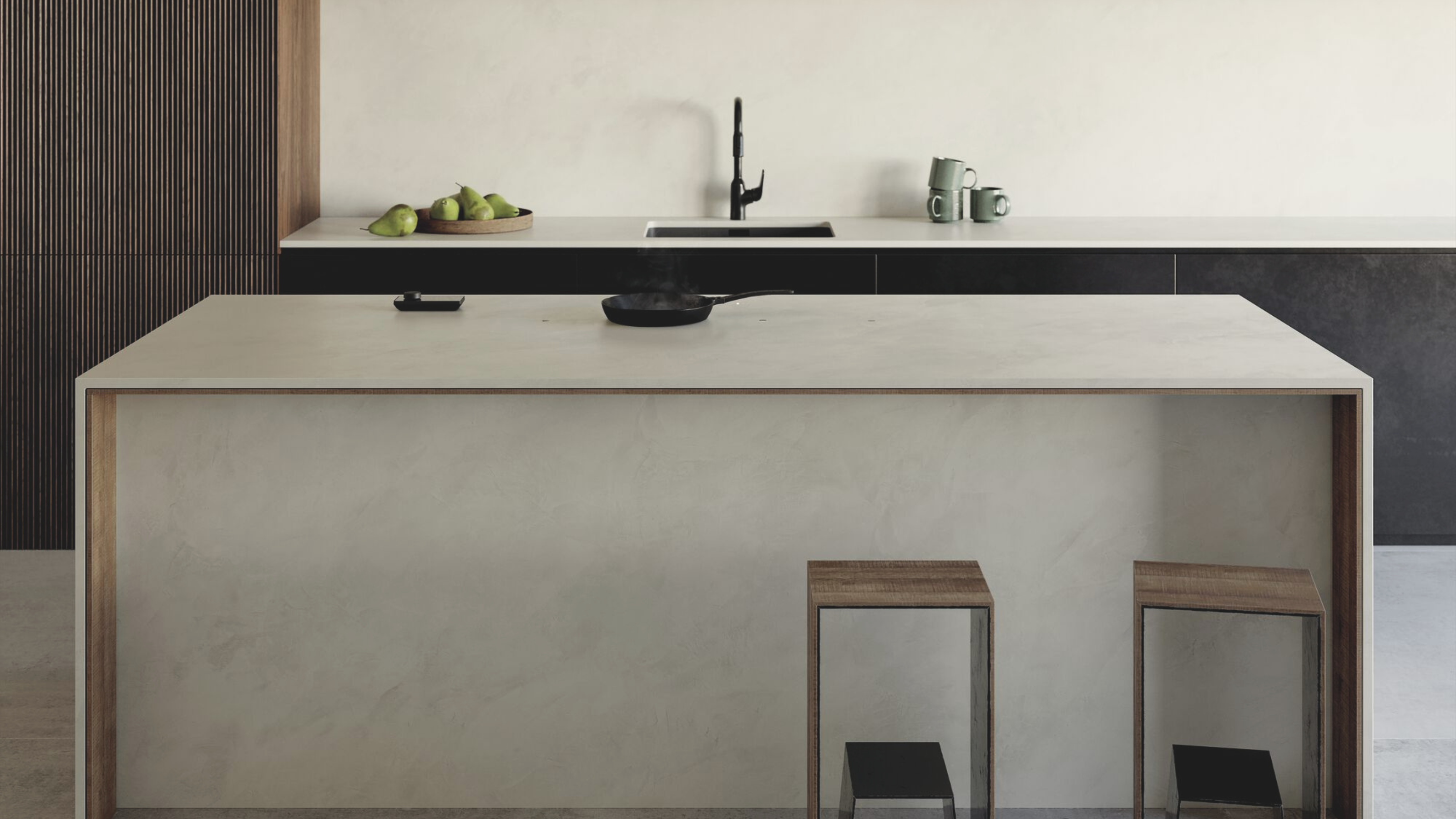 the novy undercover hob in a modern kitchen with black cabinets and a cream Dekton island