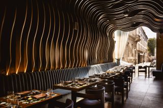 Piraña restaurant interiors with moody lighting and warm wood details