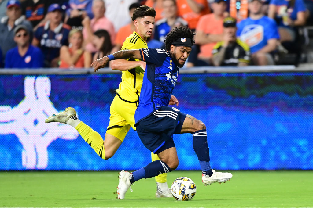 DeAndre Yedlin #91 of FC Cincinnati and Max Arfsten #27 of Columbus Crew compete for the ball during the first half of a game at TQL Stadium on September 14, 2024 in Cincinnati, Ohio