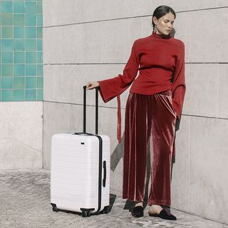 white suitcase by away