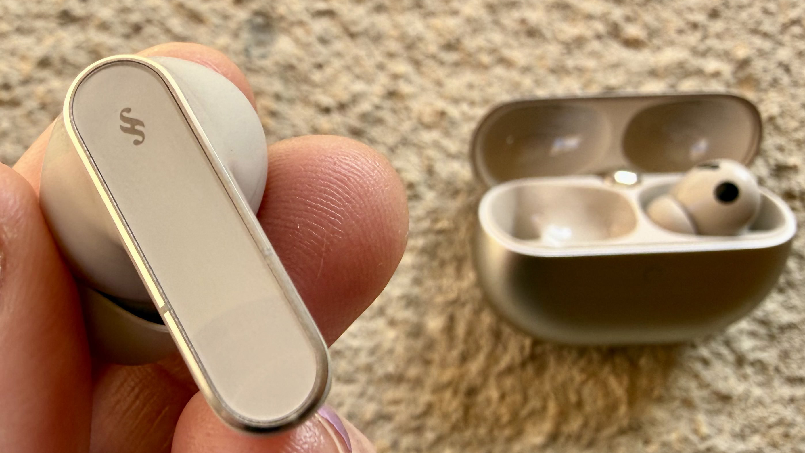 Someone holding one of the huawei freebuds pro 5 buds close to the camera