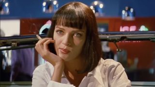 Uma Thurman as Mia Wallace with a cigarette in her hand in Pulp Fiction.