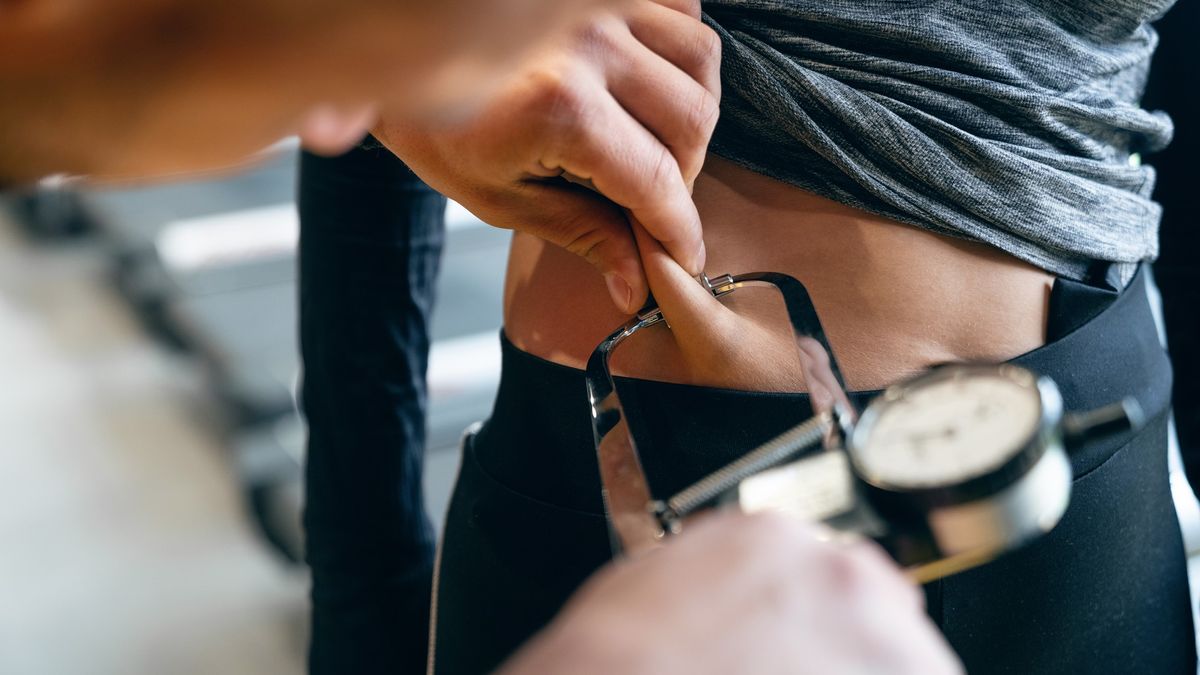 a photo of someone using body fat callipers to work out body fat percentage 