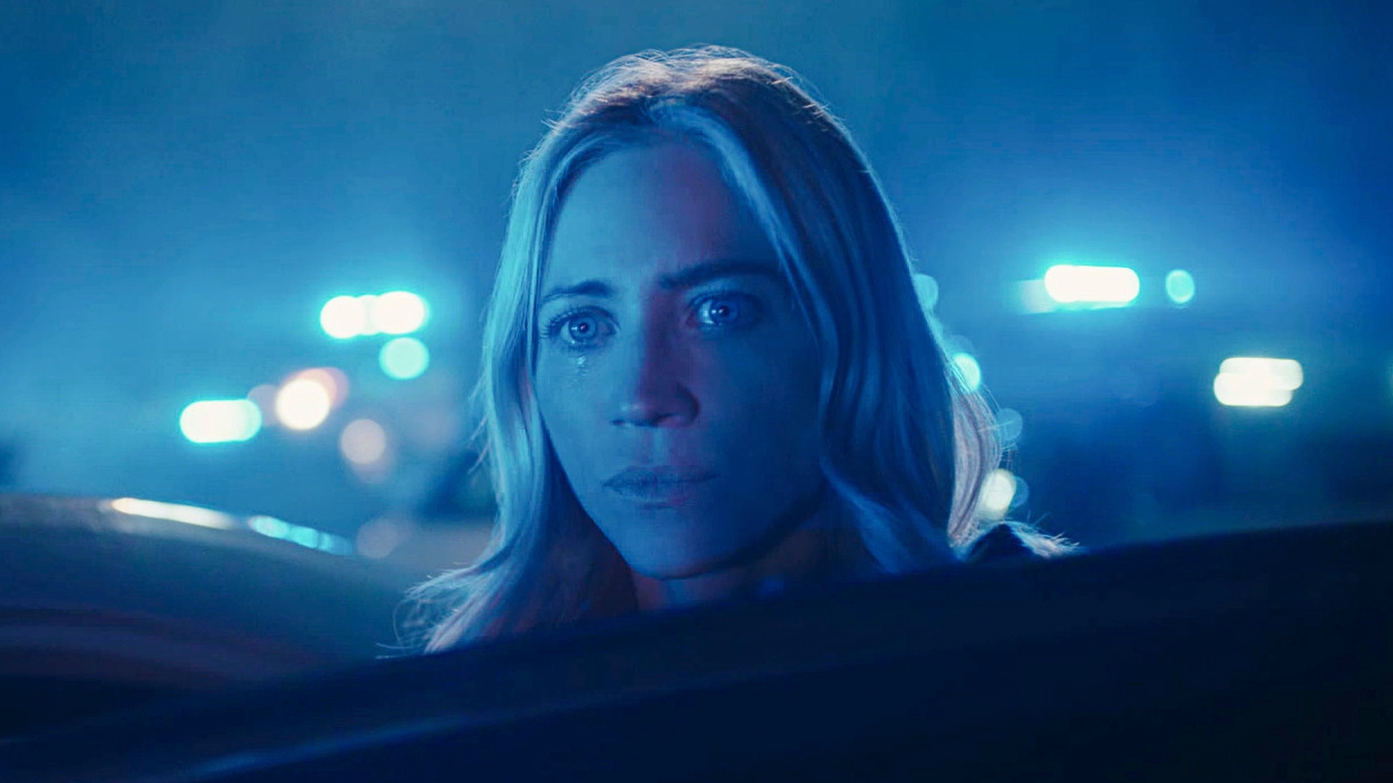 Sophie standing in blue police lights in The Hunting Wives Season 2