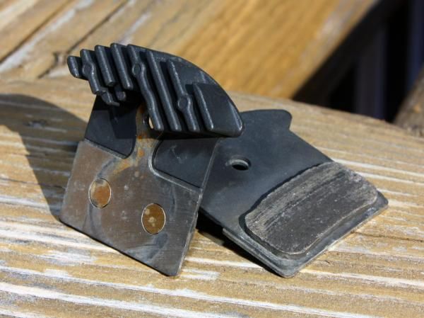 Shimano's new Ice Tech disc brake pads feature cast aluminum heatsinks to help dissipate heat. They'll come standard in Trail-edition XTR brakes but are also compatible with the otherwise identical Race calipers.