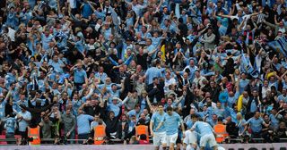The City fans celebrate after Yaya Toure of Manchester City scored the opening goal during the FA Cup sponsored by E.ON semi final match between Manchester City and Manchester United at Wembley Stadium on April 16, 2011 in London, England.