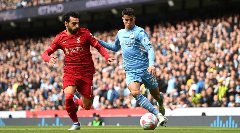 Liverpool&#039;s Mohamed Salah challenges Manchester City&#039;s Joao Cancelo.