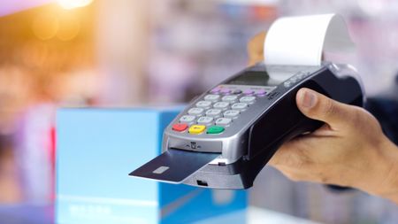 Person pays using POS hardware card reader