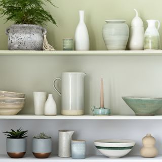 shelves on wall with ombre striped wall and jug with candle stick and bowl