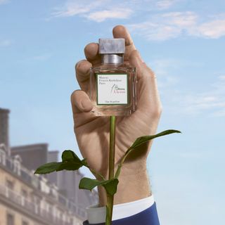 Males hand holding a bottle of Maison Francis Kurkdjian perfume