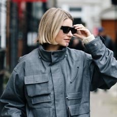 A woman with a blonde blunt bob haircut and sunglasses