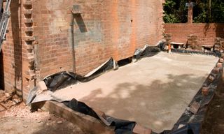 laying footing foundation with brick wall