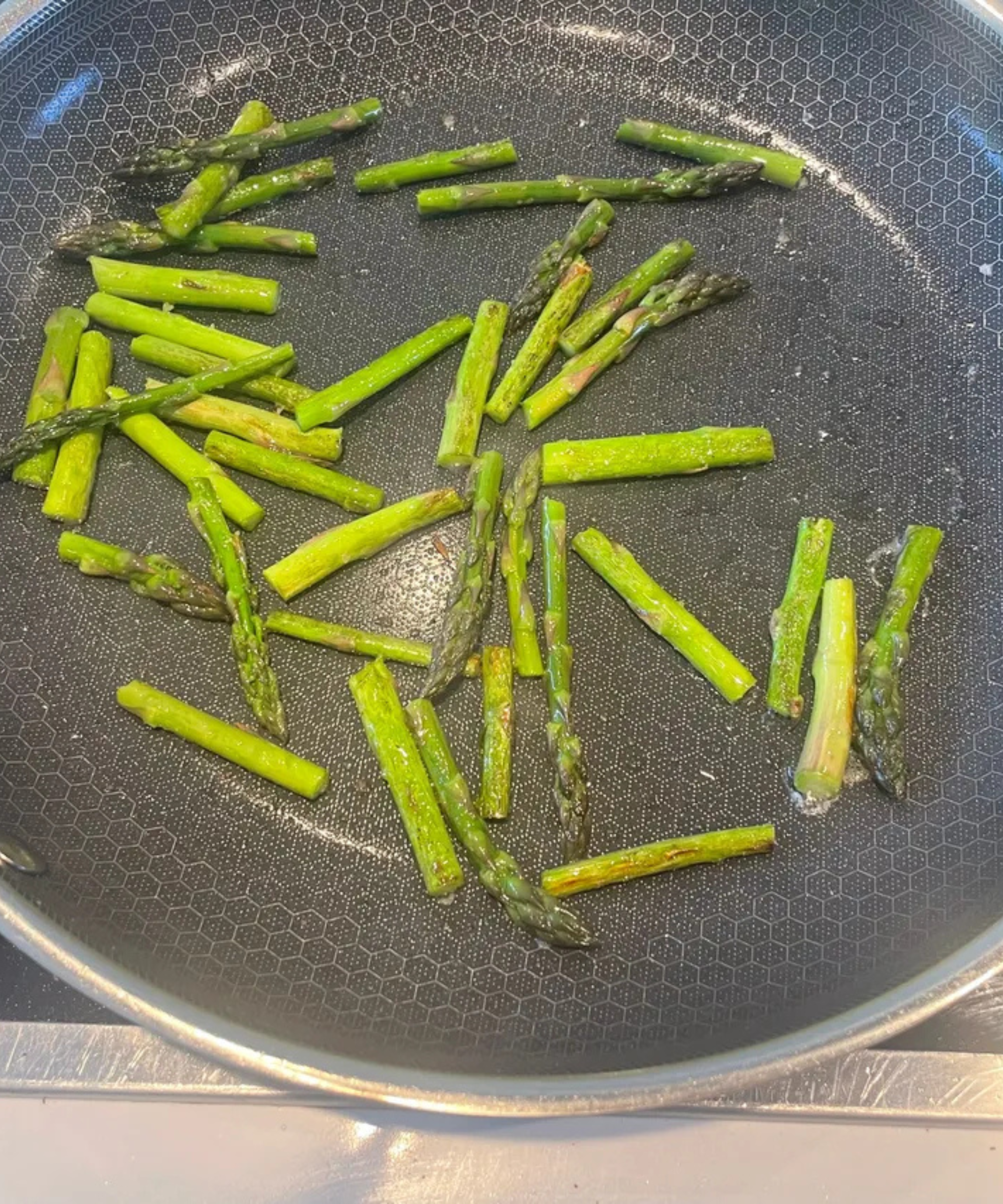 Frying fresh asparagus in the HexClad Hybrid Fry Pan