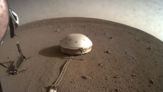 a metal dome seen on a reddish rocky surface