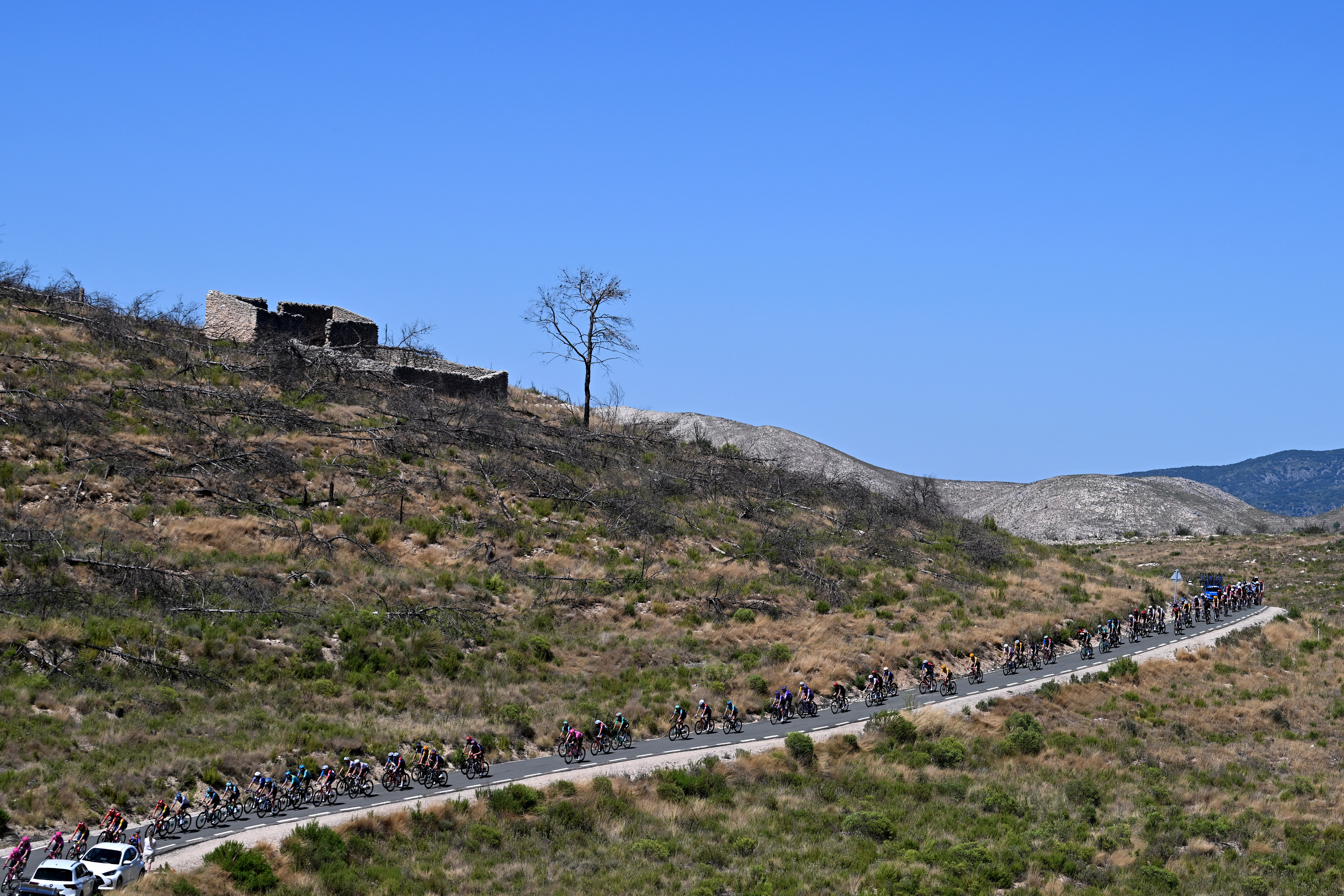 ALTO DE AITANA, SPAIN - AUGUST 30: A general view of the peloton passing the Puerto de Tollos (830m) during the La Vuelta - 81st Tour of Spain 2026, Stage 9 a 187.4km stage from Villajoyosa to Alto de Aitana 1544m / #UCIWT / on August 30, 2026 in Alto de Aitana, Spain. (Photo by Tim de Waele/Getty Images)