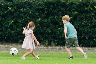 Prince George and Princess Charlotte playing football